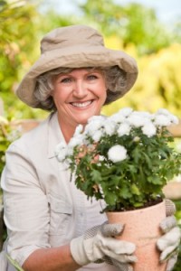 Older Woman Holding Potted Flowers