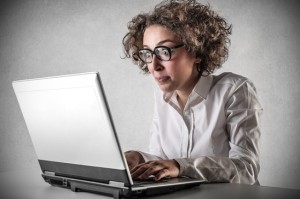 Woman Looking at Laptop Shocked